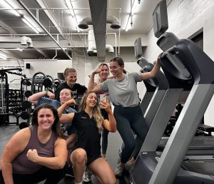 small group training flexing in mirror together